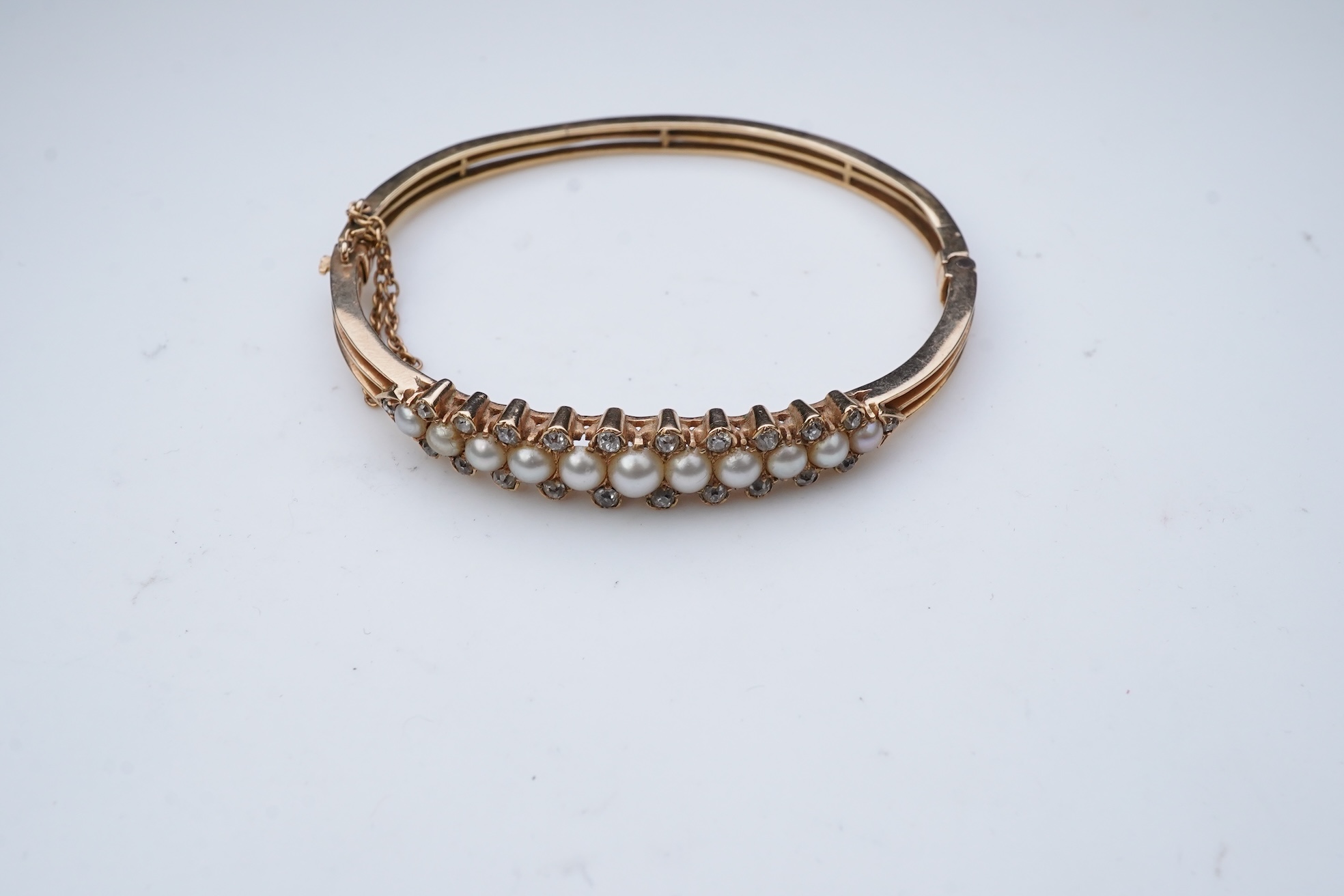 An Edwardian pearl and diamond bangle, early 20th century